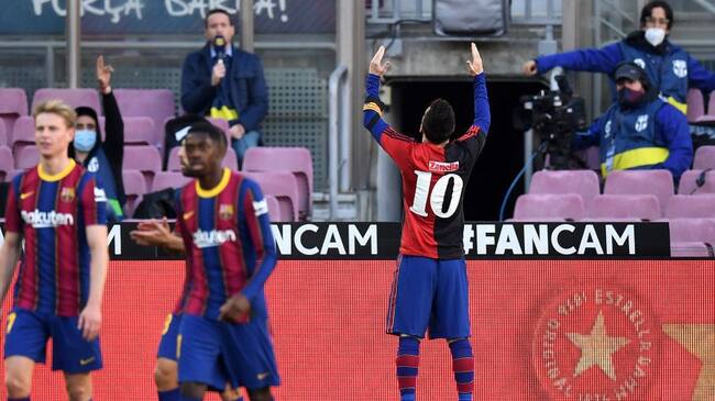 BARCELONA, SPAIN - NOVEMBER 29: Lionel Messi of Barcelona celebrates after scoring their sides fourth goal while wearing a Newell's Old Boys shirt with the number 10 on the back in memory of former footballer, Diego Maradona, who recently passed away during the La Liga Santander match between FC Barcelona and C.A. Osasuna at Camp Nou on November 29, 2020 in Barcelona, Spain. Sporting stadiums around Spain remain under strict restrictions due to the Coronavirus Pandemic as Government social distancing laws prohibit fans inside venues resulting in games being played behind closed doors. (Photo by David Ramos/Getty Images)