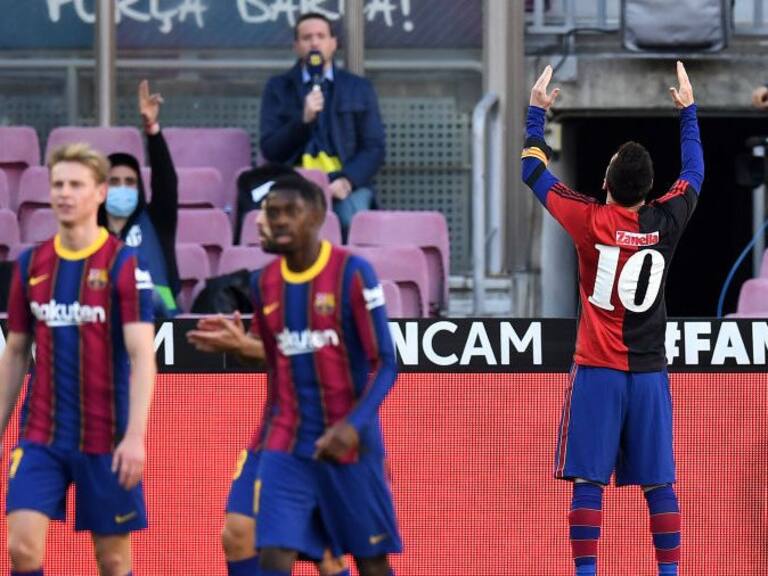 BARCELONA, SPAIN - NOVEMBER 29: Lionel Messi of Barcelona celebrates after scoring their sides fourth goal while wearing a Newell's Old Boys shirt with the number 10 on the back in memory of former footballer, Diego Maradona, who recently passed away during the La Liga Santander match between FC Barcelona and C.A. Osasuna at Camp Nou on November 29, 2020 in Barcelona, Spain. Sporting stadiums around Spain remain under strict restrictions due to the Coronavirus Pandemic as Government social distancing laws prohibit fans inside venues resulting in games being played behind closed doors. (Photo by David Ramos/Getty Images)
