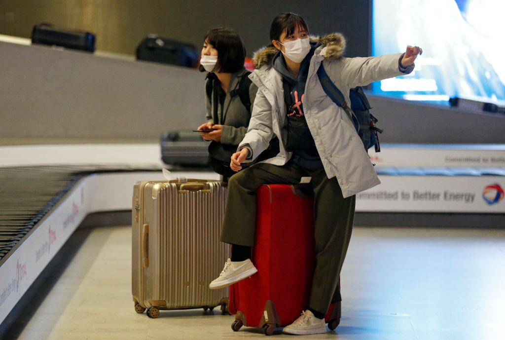 PARIS, FRANCE - FEBRUARY 10: Passengers coming from China wearing protective masks leave the Terminal after landing in Charles De Gaulle Airport on February 10, 2020 in Roissy-en-France. The Coronavirus was first detected in December in Wuhan, the capital of Hubei province, and has left at least 908 dead in mainland China, where the number of infected people exceeds 40,000, according to today’s report by the Chinese authorities. The epidemic is spreading worldwide with confirmed cases in more than 25 countries and territories. (Photo by Chesnot/Getty Images)