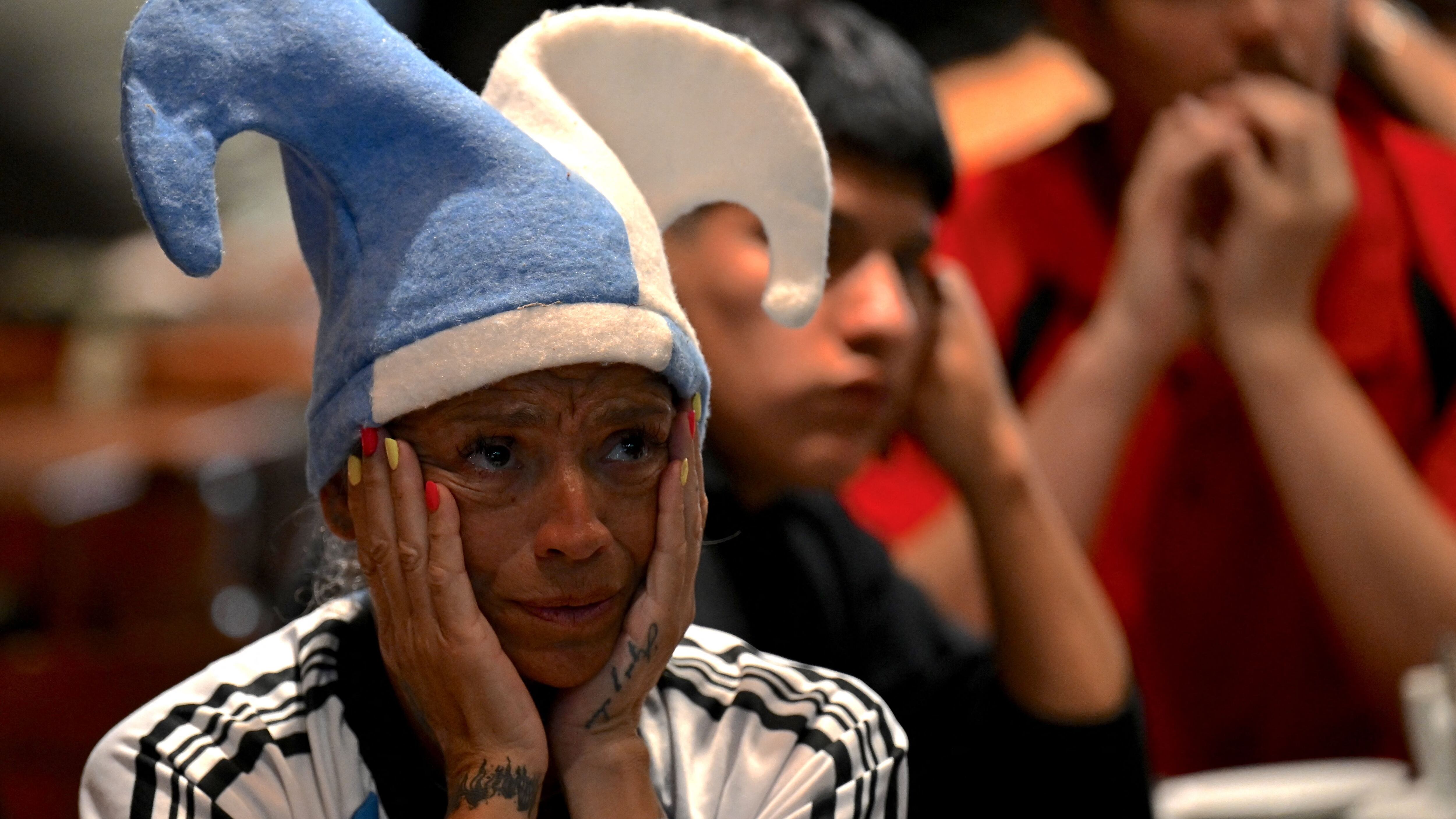 Football fans of Argentina watch the Qatar 2022 World Cup Group C football match between Argentina and Saudi Arabia on November 22, 2022 in Buenos Aires. - Saudi Arabia stunned Lionel Messi's Argentina, beating the two-time winners 2-1 in one of the biggest upsets in World Cup history. (Photo by Luis ROBAYO / AFP) (Photo by LUIS ROBAYO/AFP via Getty Images)