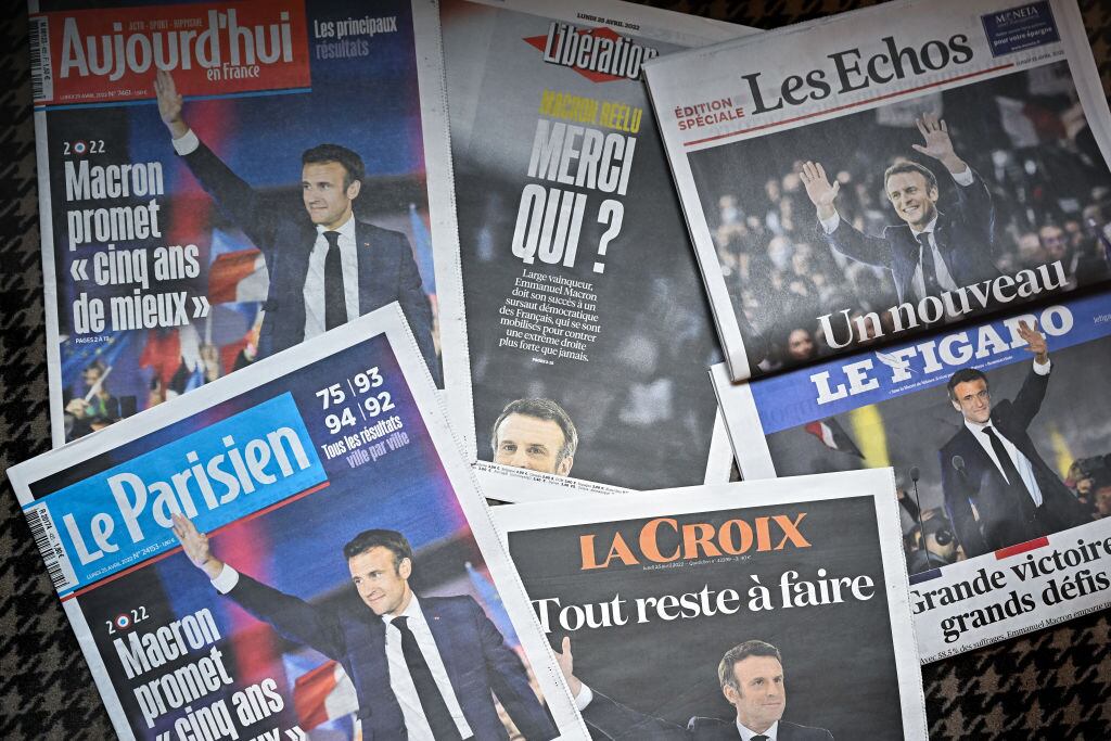 PARIS, FRANCE - APRIL 25: Front pages of the French newspapers show France's centrist incumbent president Emmanuel Macron after beating his far-right rival Marine Le Pen for a second five-year term on April 25, 2022 in Paris, France. Incumbent French president Emmanuel Macron won the 2022 presidential election on April 24, with 58.54 percent of the vote, his far-right rival Marine Le Pen won 41.46 percent of votes, according to the French Ministry of the Interior. Around 14 million voters in France refused to chose between the two finalists, one million more in abstention compared to the first round of voting on April 10 (12.8 million). (Photo by Jeff J Mitchell/Getty Images)