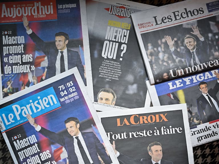 PARIS, FRANCE - APRIL 25: Front pages of the French newspapers show France&#039;s centrist incumbent president Emmanuel Macron after beating his far-right rival Marine Le Pen for a second five-year term on April 25, 2022 in Paris, France. Incumbent French president Emmanuel Macron won the 2022 presidential election on April 24, with 58.54 percent of the vote, his far-right rival Marine Le Pen won 41.46 percent of votes, according to the French Ministry of the Interior. Around 14 million voters in France refused to chose between the two finalists, one million more in abstention compared to the first round of voting on April 10 (12.8 million). (Photo by Jeff J Mitchell/Getty Images)