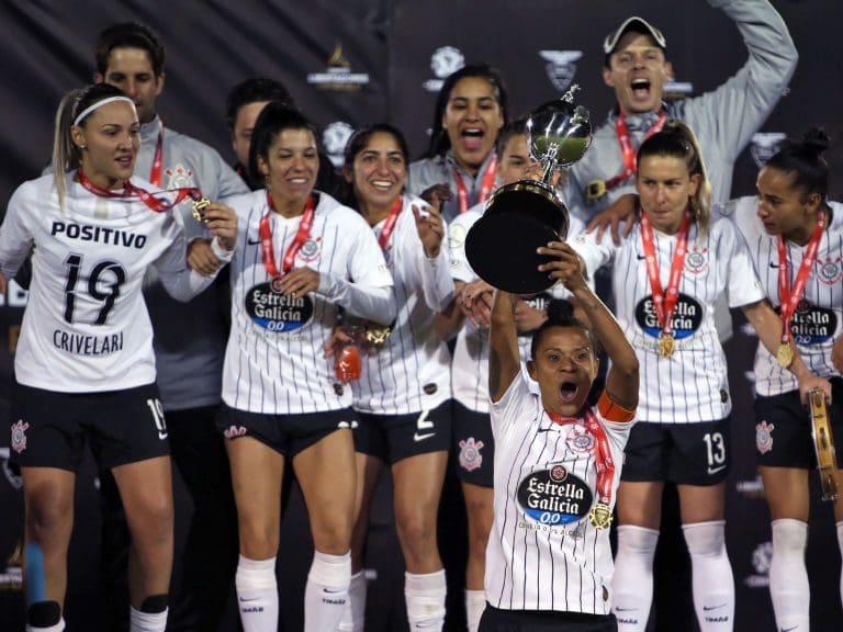 Grazi, the captain of Brazil&#039;s team Corinthians, raises the trophy on the podium after winning the women&#039;s Copa Libertadores football final match against Brazil&#039;s Ferroviaria and obtaining the title, at the Olimpico Atahualpa stadium in Quito on October 28, 2019. (Photo by Cristina Vega Rhor / AFP) (Photo by CRISTINA VEGA RHOR/AFP via Getty Images)