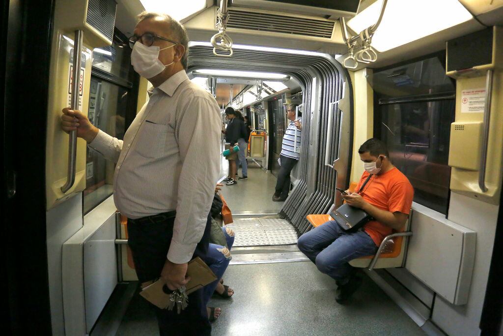 SANTIAGO, CHILE - MARCH 20: Commuters wearing face masks travel in the train maintaining distance as the underground train continues to operate but with a low flow of passengers due to the coronavirus pandemic on March 20, 2020 in Santiago, Chile. The "state of catastrophe" declared by president Sebastian Piñera gives the government extraordinary powers to restrict freedom of movement and assure food supply and basic services for 90 days to confront the spread of COVID-19. (Photo by Marcelo Hernandez/Getty Images)