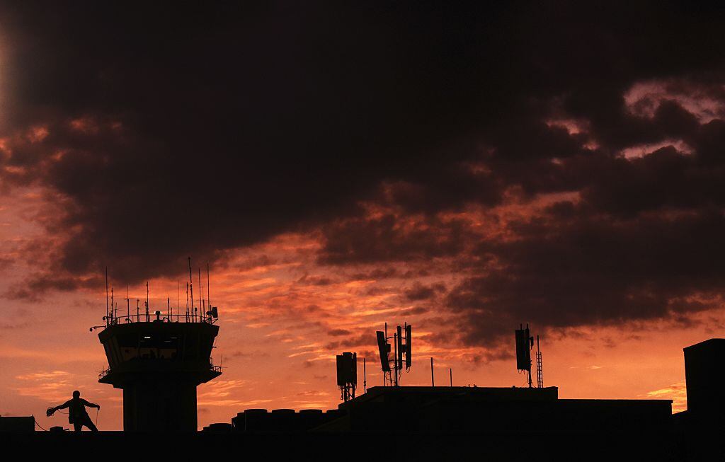 A man works on an tower at the "Monsignor Oscar Romero" international airport in San Luis Talpa 45 km. south of San Salvador, on August 11, 2015. AFP PHOTO / MARVIN RECINOS (Photo credit should read Marvin RECINOS/AFP via Getty Images)