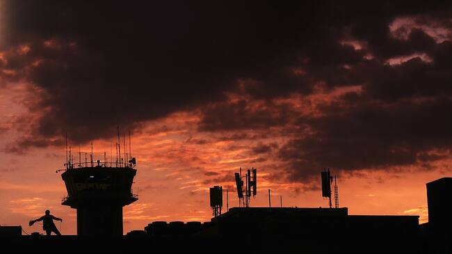 A man works on an tower at the "Monsignor Oscar Romero" international airport in San Luis Talpa 45 km. south of San Salvador, on August 11, 2015. AFP PHOTO / MARVIN RECINOS (Photo credit should read Marvin RECINOS/AFP via Getty Images)