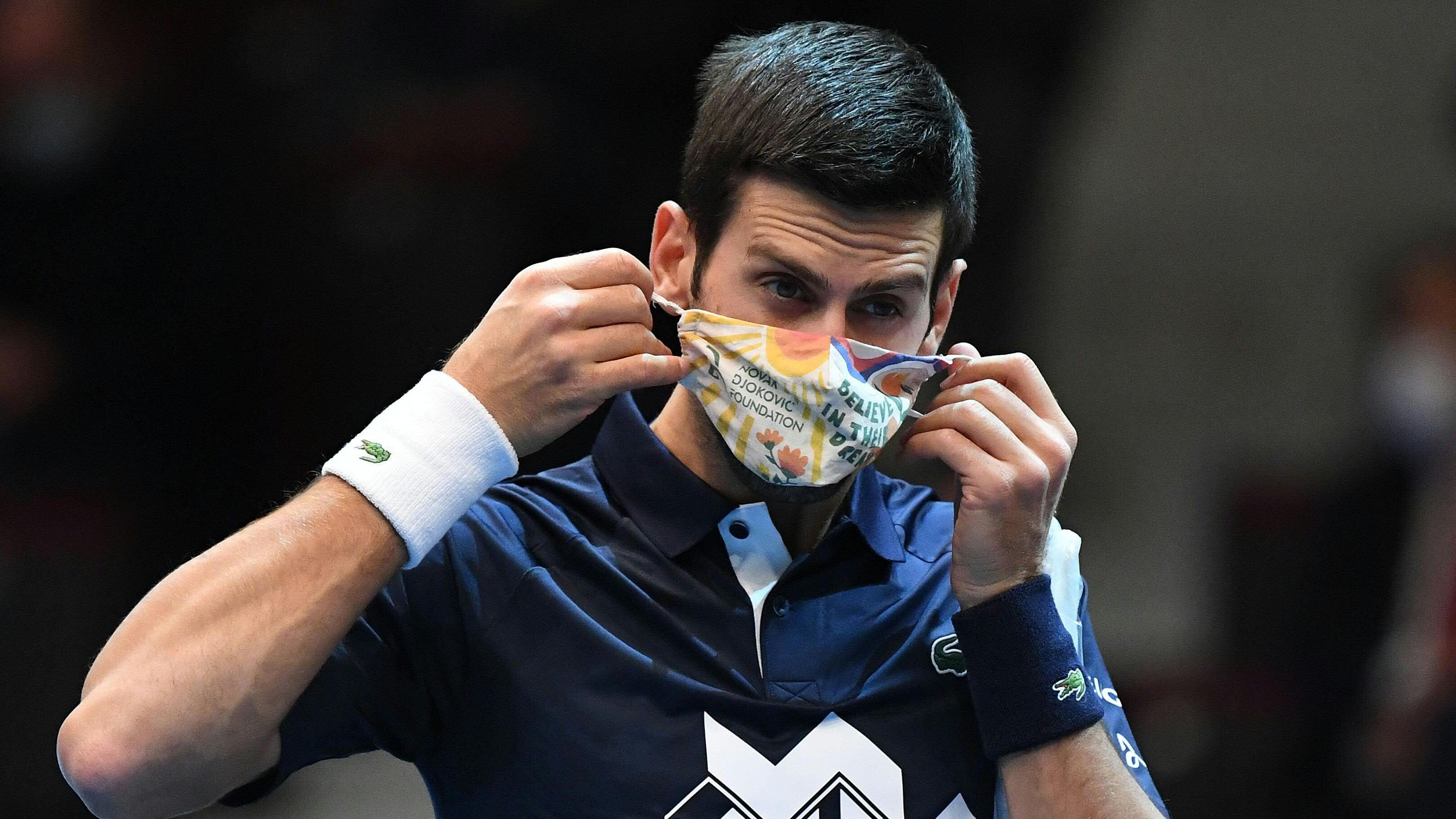 Serbia's Novak Djokovic removes his face mask before his match against Croatia's Borna Coric during the Erste Bank Open ATP tennis tournament in Vienna, on October 28, 2020. (Photo by HELMUT FOHRINGER / APA / AFP) / Austria OUT (Photo by HELMUT FOHRINGER/APA/AFP via Getty Images)