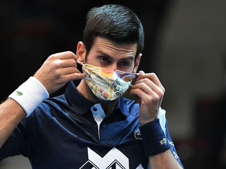 Serbia's Novak Djokovic removes his face mask before his match against Croatia's Borna Coric during the Erste Bank Open ATP tennis tournament in Vienna, on October 28, 2020. (Photo by HELMUT FOHRINGER / APA / AFP) / Austria OUT (Photo by HELMUT FOHRINGER/APA/AFP via Getty Images)
