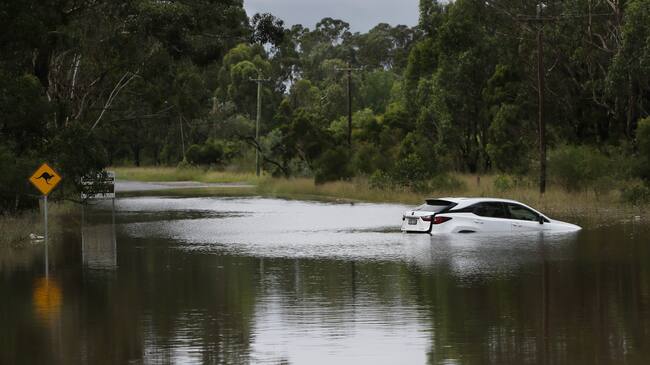 SYDNEY, AUSTRALIA - MARCH 03: A vehicle is seen partly submerged under rising floodwaters along the Hawkesbury River in the suburb of Windsor on March 03, 2021 in Sydney, Australia. Thousands are being told to evacuate Sydney suburbs with 50-250 millimetres of rainfall expected today. (Photo by Lisa Maree Williams/Getty Images)