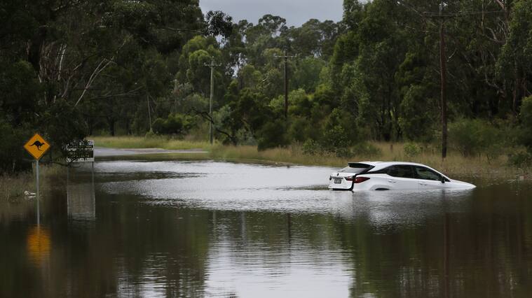 SYDNEY, AUSTRALIA - MARCH 03: A vehicle is seen partly submerged under rising floodwaters along the Hawkesbury River in the suburb of Windsor on March 03, 2021 in Sydney, Australia. Thousands are being told to evacuate Sydney suburbs with 50-250 millimetres of rainfall expected today. (Photo by Lisa Maree Williams/Getty Images)