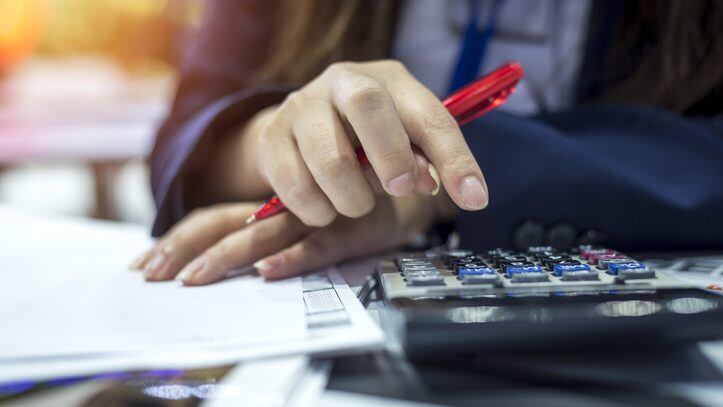 Hands of bank officer calculating loans