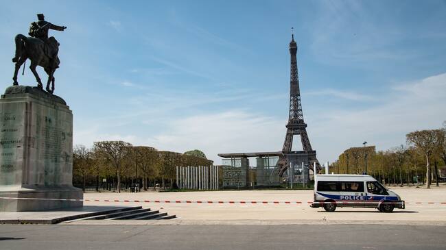 A police van is parked in the closed Jardin du Champs de Mars garden in front of the Eiffel tower in Paris on April 7, 2020, the 22nd day of a lockdown in France aimed at curbing the spread of the COVID-19 pandemic, caused by the novel coronavirus. (Photo by BERTRAND GUAY / AFP) (Photo by BERTRAND GUAY/AFP via Getty Images)