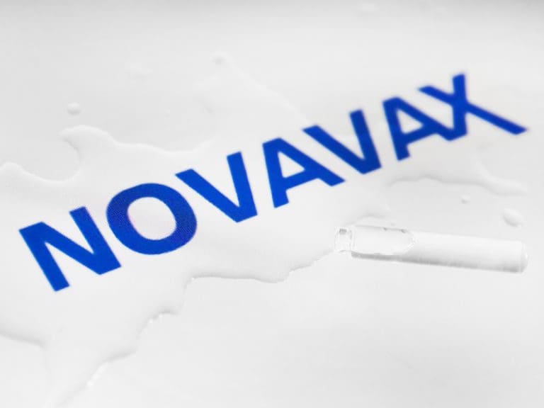 Novavax vaccine manufacturer logo is photographed with a vial and spilled liquid for an illustration photo. Krakow, Poland on May 5th, 2021. Within less than 12 months after the beginning of the COVID-19 pandemic, several research teams rose to the challenge and developed vaccines that protect from SARS-CoV-2, the virus that causes COVID-19. (Photo by Beata Zawrzel/NurPhoto via Getty Images)