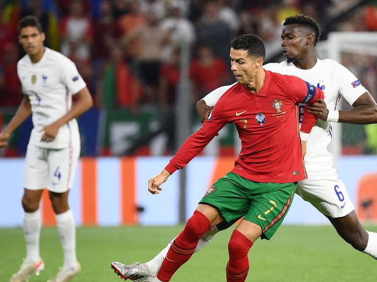 France&#039;s midfielder Paul Pogba (R) and Portugal&#039;s forward Cristiano Ronaldo vie for the ball during the UEFA EURO 2020 Group F football match between Portugal and France at Puskas Arena in Budapest on June 23, 2021. (Photo by FRANCK FIFE / POOL / AFP) (Photo by FRANCK FIFE/POOL/AFP via Getty Images)