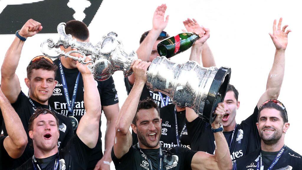 AUCKLAND, NEW ZEALAND - MARCH 17: Emirates Team New Zealand's Blair Tuke receive the "Auld Mug" trophy during the podium presentation after winning race #10 and the American's Cup against Luna Rossa Prada Pirelli Team on March 17, 2021 in Auckland, New Zealand. (Photo by Fiona Goodall/Getty Images)