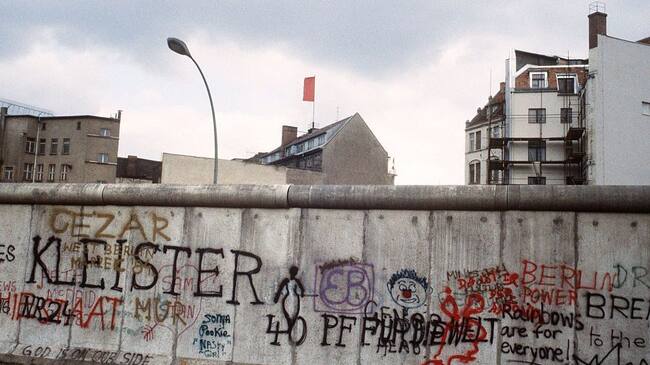 Various graffiti are painted on the Berlin Wall on the West Berlin side on April 29, 1984. The Berlin wall built by the East German government to seal off East Berlin from the part of the city occupied by the three main western powers (USA, Great Britain and France), and to prevent mass illegal emigration to the West. The wall, built along the border between German Democratic Republic (GDR) and Federal Republic of Germany, was the scene of the shooting of many East Germans who tried to escape from GDR. The two countries remained divided until November 1989 when the wall was unexpectedly opened following increased pressure for political reform in GDR. / AFP / JOEL ROBINE (Photo credit should read JOEL ROBINE/AFP via Getty Images)