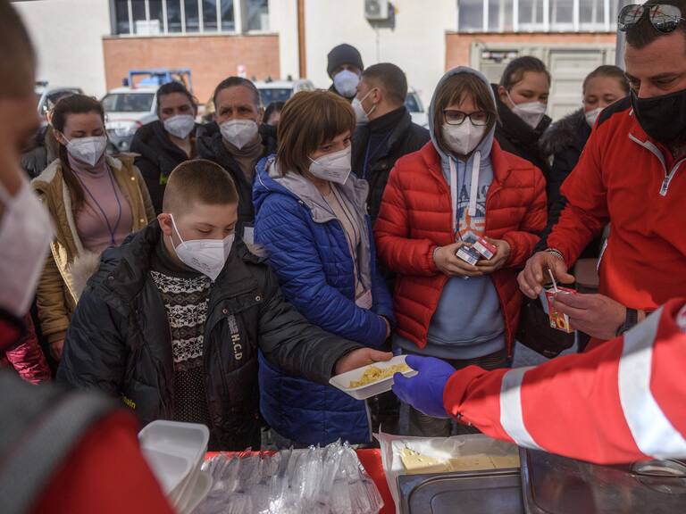 ROME, ITALY - MARCH 22: Ukrainian refugees evacuated from Lviv receive hot meals brought by Italian Red Cross volunteers, on March 22, 2022 in Rome, Italy. About 80 frail people including children, elderly and disabled were evacuated from Lutsk, Kharhiv and Kiev by the Italian Red Cross in collaboration with the Civil Protection Department. (Photo by Antonio Masiello/Getty Images)