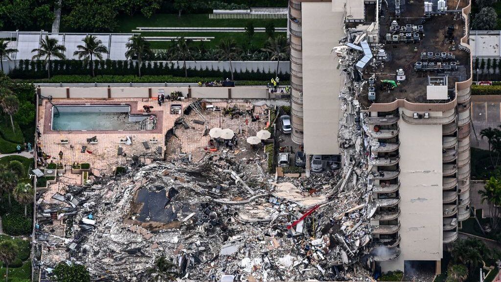 This aerial view, shows search and rescue personnel working on site after the partial collapse of the Champlain Towers South in Surfside, north of Miami Beach, on June 24, 2021. - The multi-story apartment block in Florida partially collapsed early June 24, sparking a major emergency response. Surfside Mayor Charles Burkett told NBCs Today show: My police chief has told me that we transported two people to the hospital this morning at least and one has died. We treated ten people on the site. (Photo by CHANDAN KHANNA / AFP) (Photo by CHANDAN KHANNA/AFP via Getty Images)