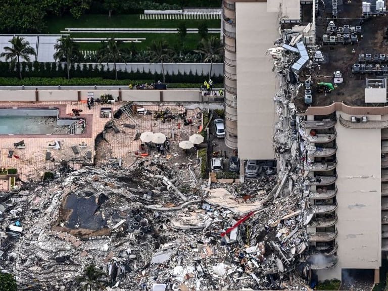 This aerial view, shows search and rescue personnel working on site after the partial collapse of the Champlain Towers South in Surfside, north of Miami Beach, on June 24, 2021. - The multi-story apartment block in Florida partially collapsed early June 24, sparking a major emergency response. Surfside Mayor Charles Burkett told NBCs Today show: My police chief has told me that we transported two people to the hospital this morning at least and one has died. We treated ten people on the site. (Photo by CHANDAN KHANNA / AFP) (Photo by CHANDAN KHANNA/AFP via Getty Images)