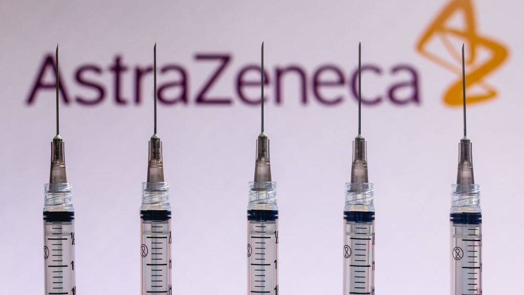 BRAZIL - 2020/12/04: In this photo illustration various medical syringes seen with AstraZeneca company logo displayed on a screen in the background. (Photo Illustration by Rafael Henrique/SOPA Images/LightRocket via Getty Images)