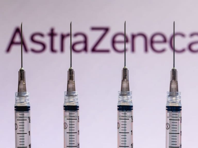 BRAZIL - 2020/12/04: In this photo illustration various medical syringes seen with AstraZeneca company logo displayed on a screen in the background. (Photo Illustration by Rafael Henrique/SOPA Images/LightRocket via Getty Images)