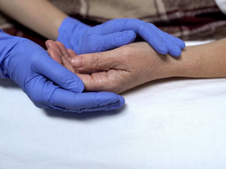 Nurse supporting and calming down patient before procedure caring hospital staff