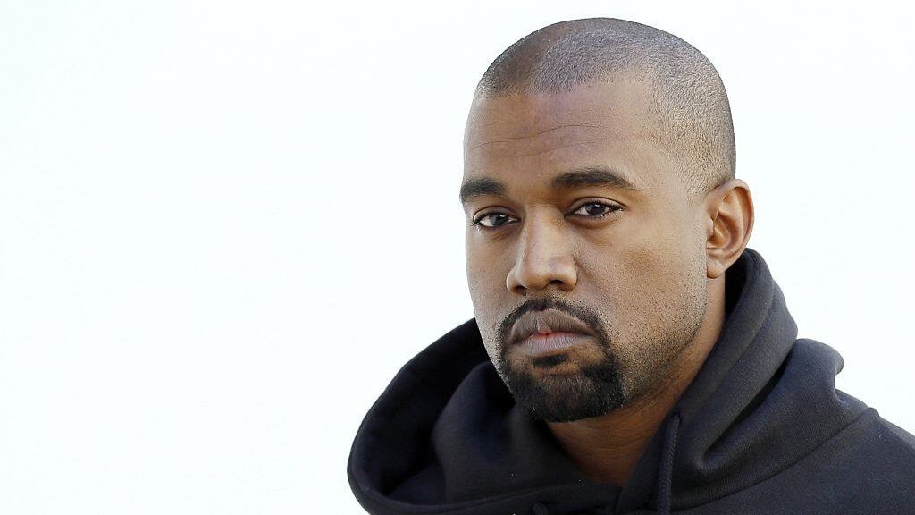 American rapper Kanye West poses before Christian Dior 2015-2016 fall/winter ready-to-wear collection fashion show on March 6, 2015 in Paris. AFP PHOTO / PATRICK KOVARIK        (Photo credit should read PATRICK KOVARIK/AFP via Getty Images)