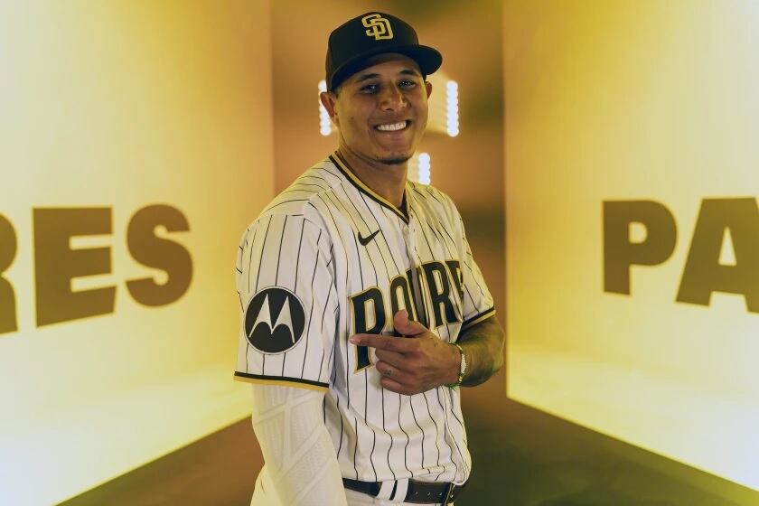 Manny Machado apuntando al logo publicitario en la camiseta edición 2023