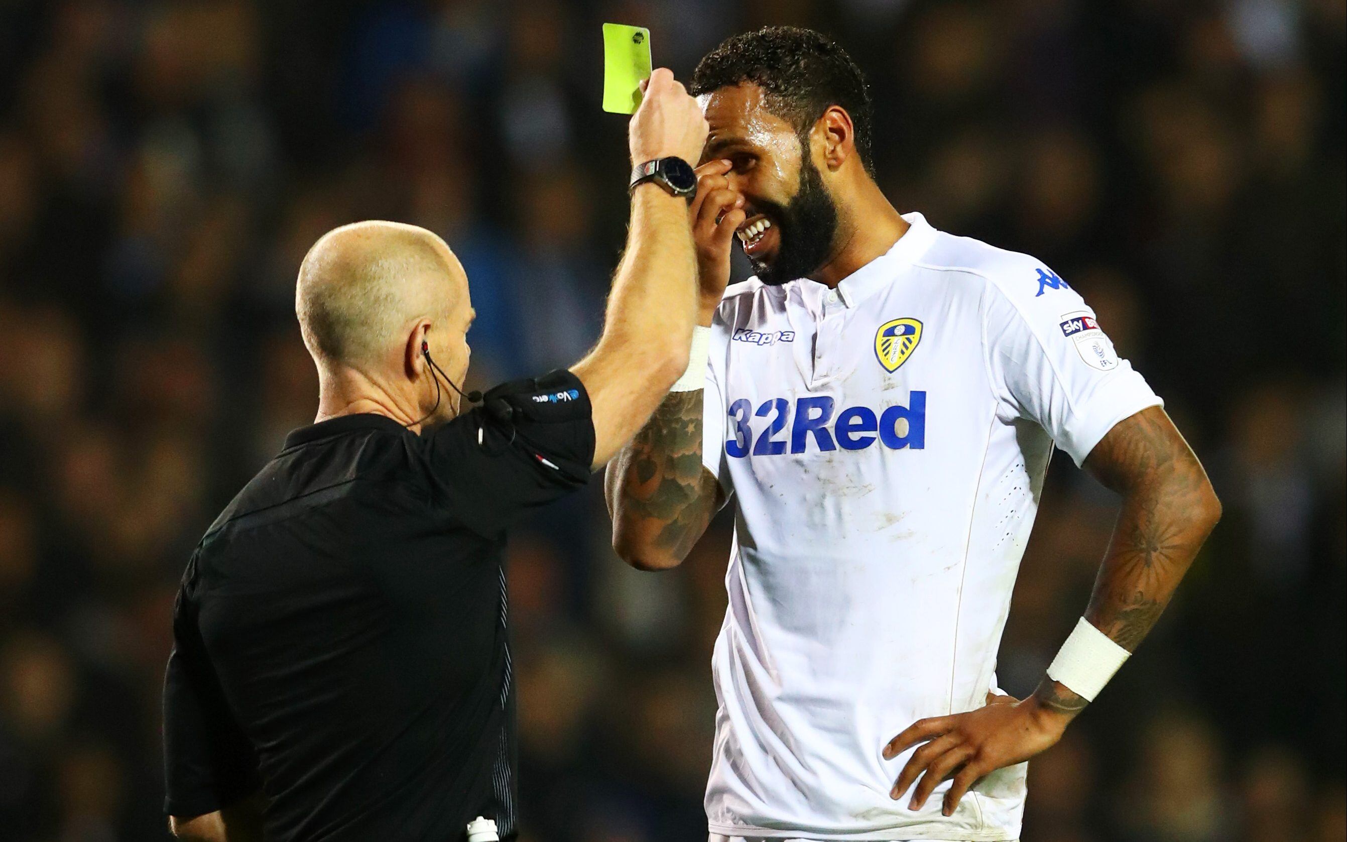 LEEDS, ENGLAND - OCTOBER 25: Kyle Bartley of Leeds United (R) is show a yellow card for handling the ball into the net during the EFL Cup fourth round match between Leeds United and Norwich City at Elland Road on October 25, 2016 in Leeds, England. (Photo by Matthew Lewis/Getty Images)