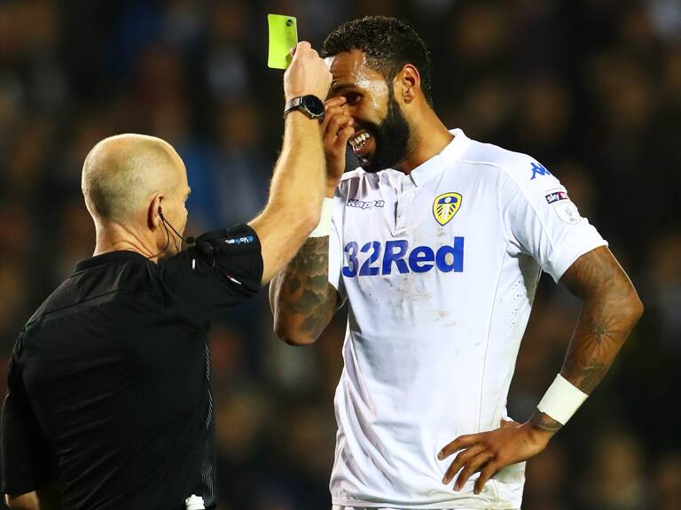 LEEDS, ENGLAND - OCTOBER 25: Kyle Bartley of Leeds United (R) is show a yellow card for handling the ball into the net during the EFL Cup fourth round match between Leeds United and Norwich City at Elland Road on October 25, 2016 in Leeds, England.  (Photo by Matthew Lewis/Getty Images)