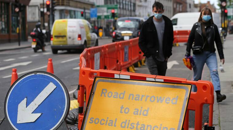 A sign is pictured explaining that the road has been narrowed to aid social distancing when using Camden High Street in central London on May 11, 2020, as life in Britain continues during the nationwide lockdown due to the novel coronavirus pandemic. - British Prime Minister Boris Johnson on May 10 announced a phased plan to ease a nationwide coronavirus lockdown, with schools and shops to begin opening from June 1 -- as long as infection rates stay low. Starting this week, he said the government would be "actively encouraging" people to return to work where they could not do so from home, for example in manufacturing or construction. (Photo by ISABEL INFANTES / AFP) (Photo by ISABEL INFANTES/AFP via Getty Images)