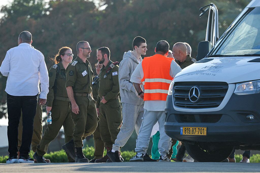 Israeli soldiers and medics accompany Maxim Herkin, formerly held hostage in Gaza since October 2023 by Palestinian militants, upon his arrival at the Sheba Tel-HaShomer Medical Centre in Ramat Gan on October 13, 2025. (Photo by Ahmad GHARABLI / AFP) (Photo by AHMAD GHARABLI/AFP via Getty Images)          