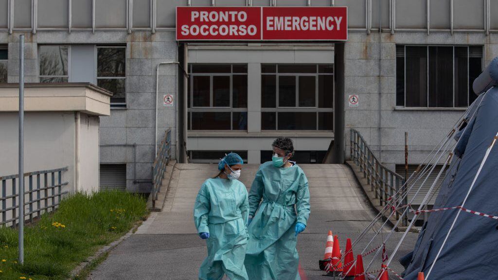 MILAN, ITALY - MARCH 20: Two nurses walk in front of the Emergency Room of the local hospital on March 20, 2020 in Cremona, near Milan, Italy. The Italian government continues to enforce the nationwide lockdown measures to control the spread of COVID-19. (Photo by Emanuele Cremaschi/Getty Images)