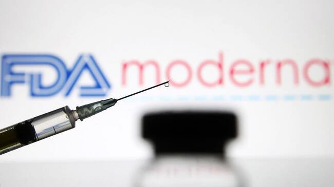 UKRAINE - 2020/12/15: In this photo illustration, a vial and a medical syringe seen displayed in front of the Food and Drug Administration (FDA) of the United States and Moderna biotechnology company's logos. FDA finds the COVID-19 vaccine. (Photo Illustration by Pavlo Gonchar/SOPA Images/LightRocket via Getty Images)