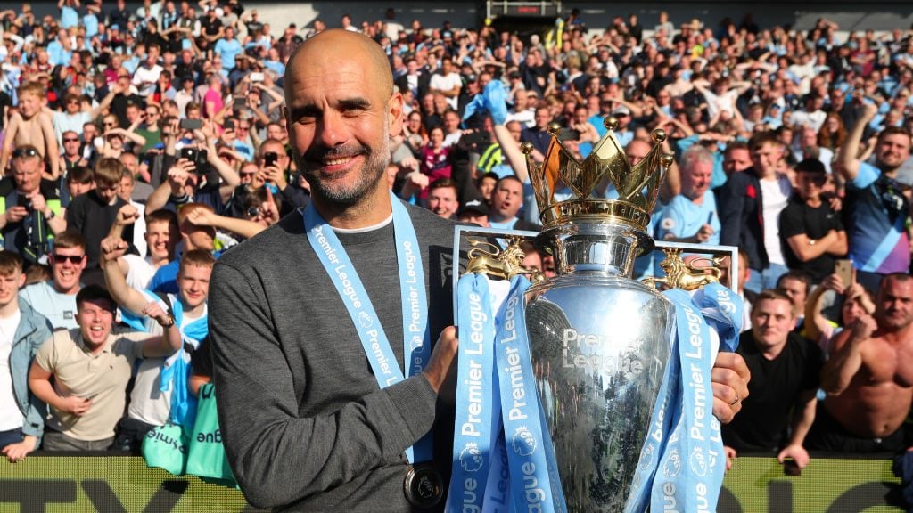 BRIGHTON, ENGLAND - MAY 12: Josep Guardiola, Manager of Manchester City celebrates with the Premier League Trophy after winning the title following the Premier League match between Brighton & Hove Albion and Manchester City at American Express Community Stadium on May 12, 2019 in Brighton, United Kingdom. (Photo by Victoria Haydn/Manchester City FC via Getty Images)