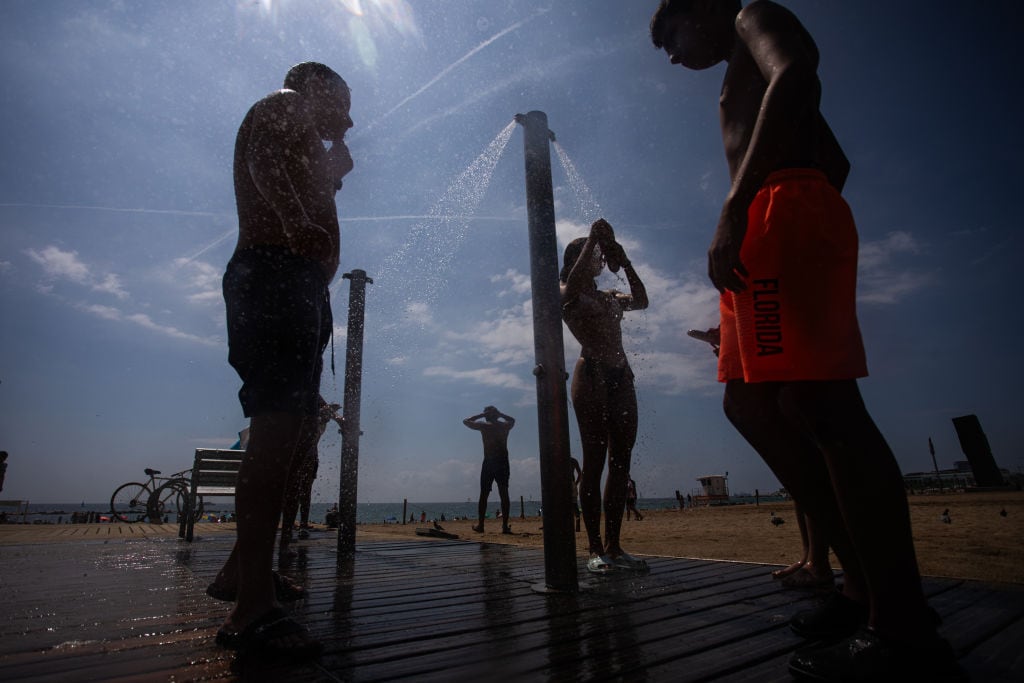 En Barcelona de España las personas se dan duchas en la calle ante la ola de calor