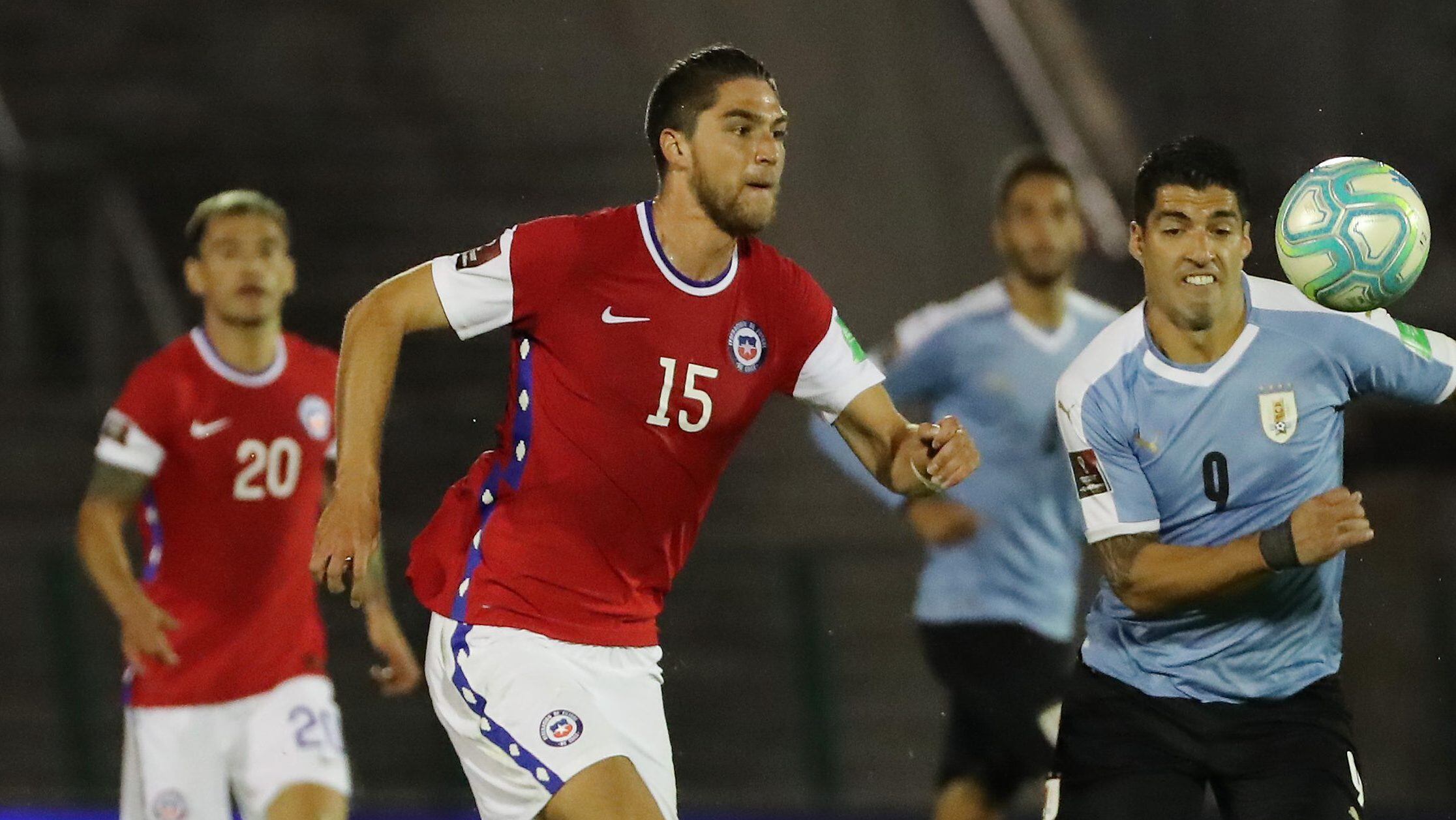 MONTEVIDEO, URUGUAY - OCTOBER 08: Luis Suarez of Uruguay fights for the ball with Francisco Sierralta of Chile during a match between Uruguay and Chile as part of South American Qualifiers for Qatar 2022 at Centenario Stadium on October 08, 2020 in Montevideo, Uruguay. (Photo by Raul Martinez -Pool/Getty Images)