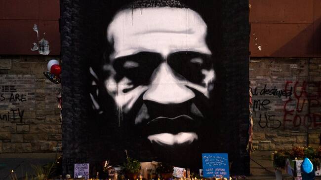 MINNEAPOLIS, MN - OCTOBER 14: LED candles are placed beneath a portrait of George Floyd during a birthday celebration for him at a memorial site known as "George Floyd Square" on October 14, 2020 in Minneapolis, Minnesota. Floyd, who was killed at the site by Minneapolis Police on May 25, would have turned 47 years old today. (Photo by Stephen Maturen/Getty Images)