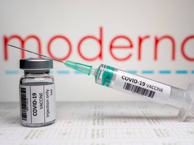 NIJMEGEN, NETHERLANDS - JANUARY 5: Covid-19 / coronavirus illustration. Vaccine with syringe and needle and bottle / vial in front of the company Moderna logo / illustration. on January 5, 2021 in Nijmegen, Netherlands (Photo by John Beckmann/BSR Agency/Getty Images)