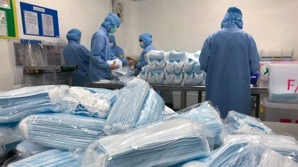 Workers produce masks at the Thai Hospital Product Company Ltd. factory in Bangkok on January 30, 2020. - A Thai surgical mask factory, producing 10 million masks a month, increased working hours to cope with the rising demand following an outbreak of SARS-like virus in China, with their product exported mostly to US and Europe the rest sold on the domestic market. (Photo by Jonathan KLEIN / AFP) (Photo by JONATHAN KLEIN/AFP via Getty Images)