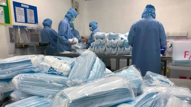 Workers produce masks at the Thai Hospital Product Company Ltd. factory in Bangkok on January 30, 2020. - A Thai surgical mask factory, producing 10 million masks a month, increased working hours to cope with the rising demand following an outbreak of SARS-like virus in China, with their product exported mostly to US and Europe the rest sold on the domestic market. (Photo by Jonathan KLEIN / AFP) (Photo by JONATHAN KLEIN/AFP via Getty Images)