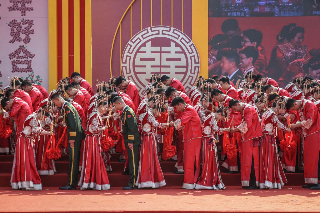 Couples in traditional Chinese costumes attend a group wedding ceremony in Yuncheng, in northern China's Shanxi province on September 22, 2024. (Photo by AFP) / China OUT (Photo by STR/AFP via Getty Images)