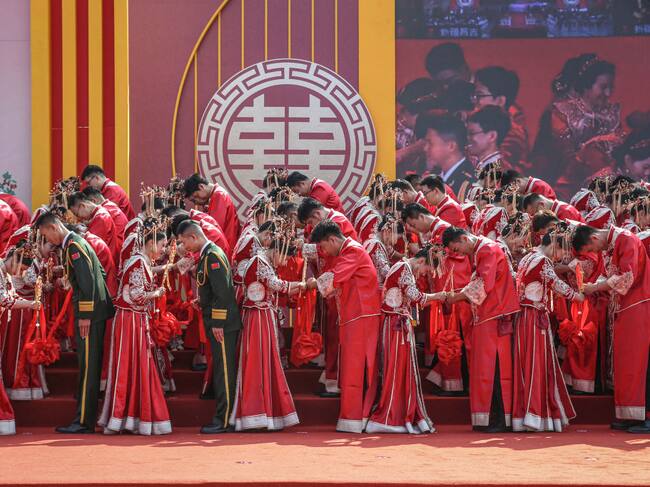 Couples in traditional Chinese costumes attend a group wedding ceremony in Yuncheng, in northern China's Shanxi province on September 22, 2024. (Photo by AFP) / China OUT (Photo by STR/AFP via Getty Images)