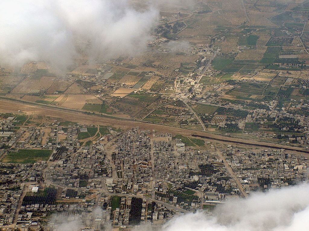 RAFAH, GAZA STRIP: (FILE PHOTO) An aerial photo taken March 12. 2004 and provided by the left-wing Israeli movement Peace Now July 27, 2004 shows the Israel's Philadelpia buffer zone on its border with Egypt (top), alongside the Palestinian town of Rafah (bottom) in the southern Gaza Strip. Israeli Prime Minister Ariel Sharon confirmed earlier this week his commitment to his Gaza withdrawal plan, even after 100,000 Israelis mounted the biggest protest against evacuating all the Jewish settlers from their 21 enclaves in the coastal strip. (Photo by Dror Etkes/Peace Now via Getty Images)