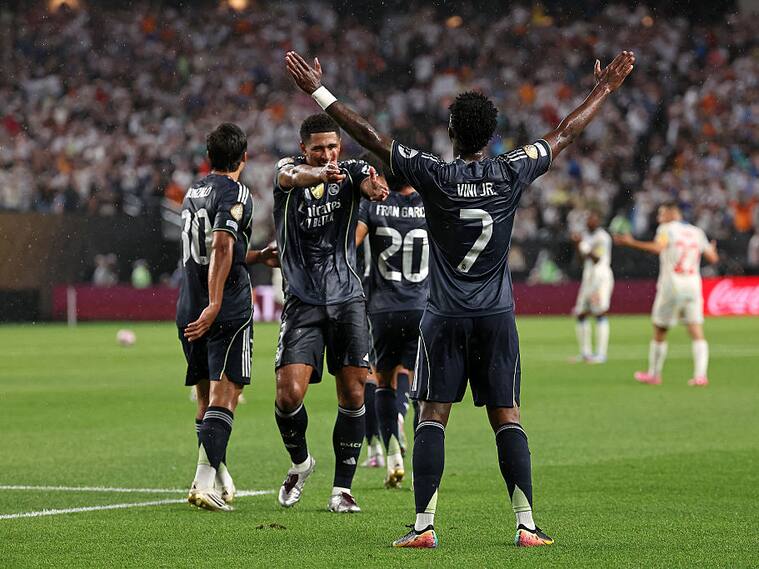 Real Madrid's Brazilian forward #07 Vinicius Junior celebrates scoring his team's first goal with Real Madrid's English midfielder #05 Jude Bellingham (C) during the FIFA Club World Cup 2025 Group H football match between Austria's FC Salzburg and Spain's Real Madrid at Lincoln Financial Field Stadium in Philadelphia on June 26, 2025. (Photo by FRANCK FIFE / AFP) (Photo by FRANCK FIFE/AFP via Getty Images)
