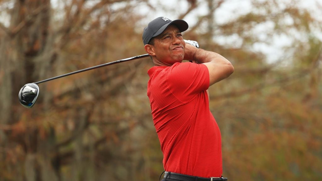 ORLANDO, FLORIDA - DECEMBER 20: Tiger Woods of the United States plays his shot from the ninth tee during the final round of the PNC Championship at the Ritz-Carlton Golf Club Orlando on December 20, 2020 in Orlando, Florida. (Photo by Mike Ehrmann/Getty Images)