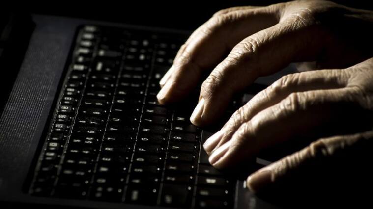 Danger concept on the internet, man's palms on a laptop keyboard