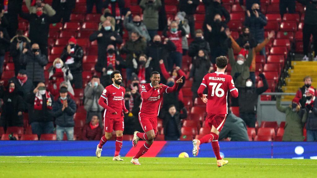 LIVERPOOL, ENGLAND - DECEMBER 06: Georginio Wijnaldum of Liverpool celebrates with team mates Mohamed Salah snd Neco Williams after scoring their sides second goal during the Premier League match between Liverpool and Wolverhampton Wanderers at Anfield on December 06, 2020 in Liverpool, England. A limited number of fans (2000) are welcomed back to stadiums to watch elite football across England. This was following easing of restrictions on spectators in tiers one and two areas only. (Photo by Jon Super - Pool/Getty Images)