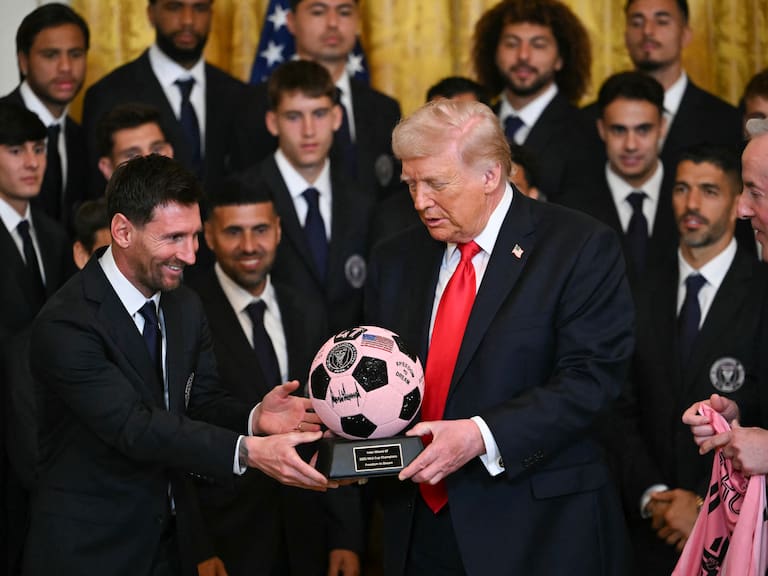 Argntinian star Lionel Messi hands US President Donald Trump a ball during an event for Inter Miami CF, winners of the 2025 Major League Soccer Cup, in the East Room of the White House in Washington, DC, on March 5, 2026. (Photo by ANDREW CABALLERO-REYNOLDS / AFP via Getty Images)