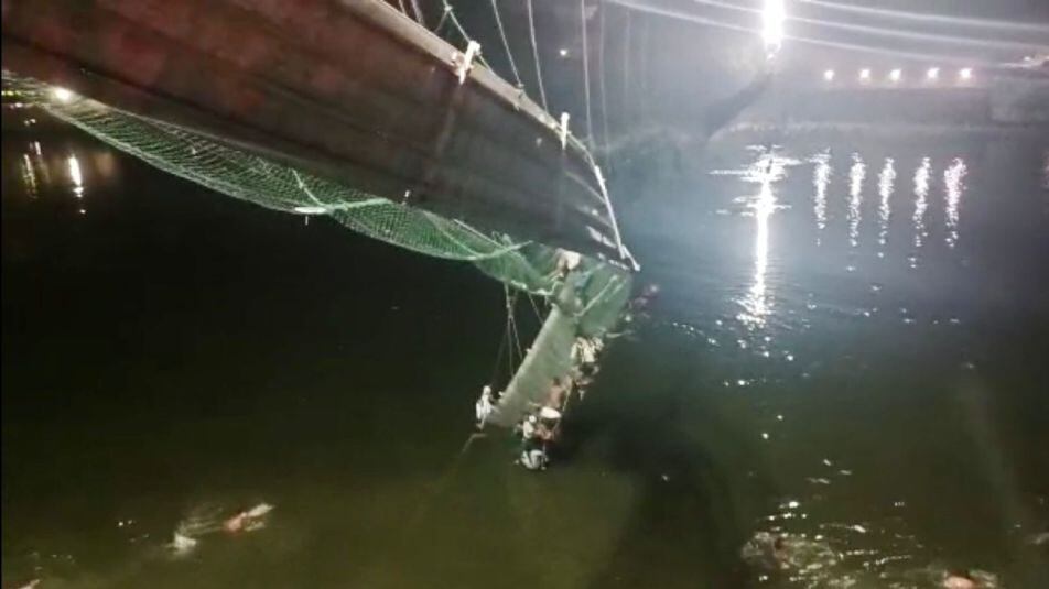 GUJARAT, INDIA - OCTOBER 30: A view of the site after a suspension bridge collapses in Indiaâs Gujarat state on October 30, 2022. Hundreds plunged into river after the bridge collapsed. (Photo by Stringer/Anadolu Agency via Getty Images)